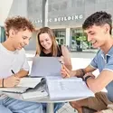 Three students at a table, studying