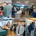 Students engage with employers and campus partners at tables during a college career and networking fair.