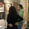 Two people looking at the art gallery wall