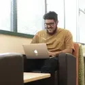 Person sitting on a laptop computer