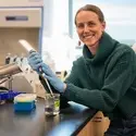 Elise Connor with a pipette at a lab counter