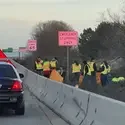 Students on the side of road picking up trash