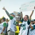 Student holding large check in front of crowd