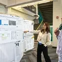 Student presenting poster to judge