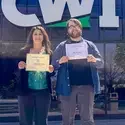 Two people with certificates