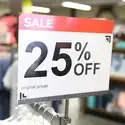 25 percent off sign on top of clothes