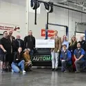 Nagel Foundation check presentation in a lab on campus, representatives holding a big check surrounded by students, staff, faculty, administration, and Nagel representatives