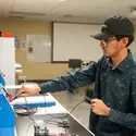 Student plugging in cords