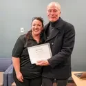 Faculty and student with a certificate