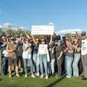 Group picture of CWI community with center person holding large check