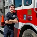 Khye Montoya leans on fire truck