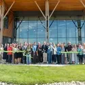 Group of people cut ribbon to new building