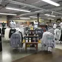 Shirts, sweaters, cups on display at Bookstore