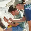 Students looking at rocks with equipment