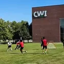 Club members playing soccer outside of the Nampa Campus Academic Building