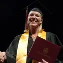 Student on stage at commencement
