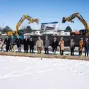 Dignitaries stand with shovels for a ceremonial groundbreaking.