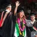 A graduate celebrates receiving her degree.