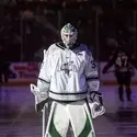 A hockey player stands on the ice.