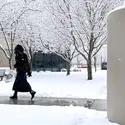 Student walking into the Ada County Campus Pintail Center in the snow