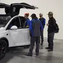 Students looking at a Tesla