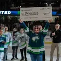 Mackenzie Nash holds a giant check on the ice