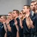 Graduates raising their hand and taking an oath