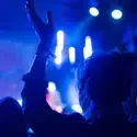 A concert goer dances during a live music performance.