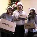 Students with amazon smile boxes in front of Christmas tree