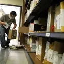 Bookstore worker packing up textbook orders to send