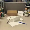 Desk with cards, envelopes, letter opener, pen, and a box