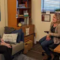 student talking to a counselor in an office