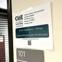 An image showing a posted sign detailing emergency contact and security information.
