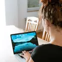 Woman on a laptop at her dining room table