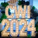 A display is pictured, comprised of large letters that say "CWI 2024" and are surrounded by balloons.