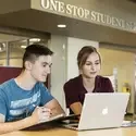 Staff assisting a student at One Stop Student Services
