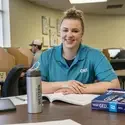 Person sitting in testing center smiling at camera