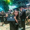 Graduate holding up degree