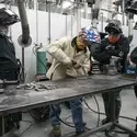 Students and faculty welding