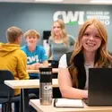Student in common area on a laptop