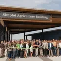 Large group gathered for a ribbon-cutting ceremony in front of the Simplot Agriculture Building at College of Western Idaho.