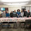 Students stand in front of food and hygiene bags