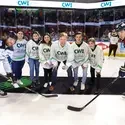 President Gordon Jones and students doing the puck drop at Steelheads game