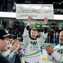 Benjamin Johnson holding up SCORE Big Scholarship check