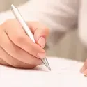 Close up of someone filling out paper work