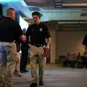Student walking across the stage shaking hands with leadership