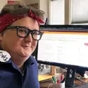 Maia Kelley, Assistant Professor of Math, working from home dressed as Rosie the Riveter