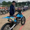 Nathaniel Dando poses with a motorcycle