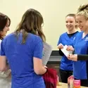 Dental Assisting students speak with visitors during the PACE event in 2015.