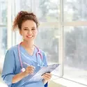 Female healthcare student carrying a clipboard